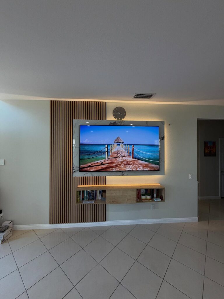 Wooden slat accent wall in a living room with a mounted television.