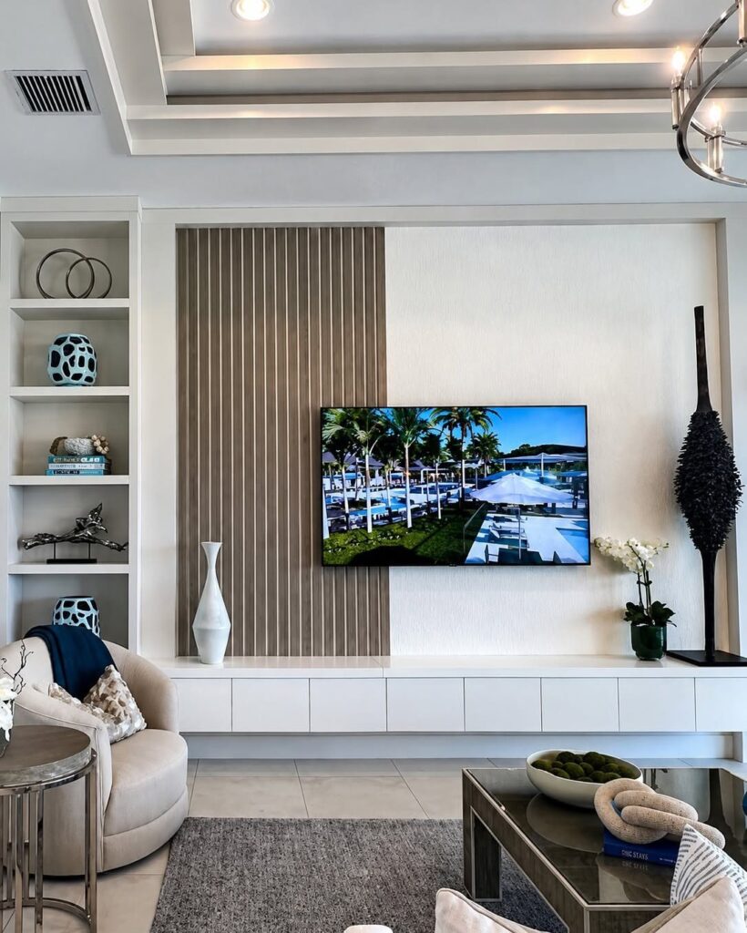 White built-in unit with open shelving and low cabinets in a modern living room