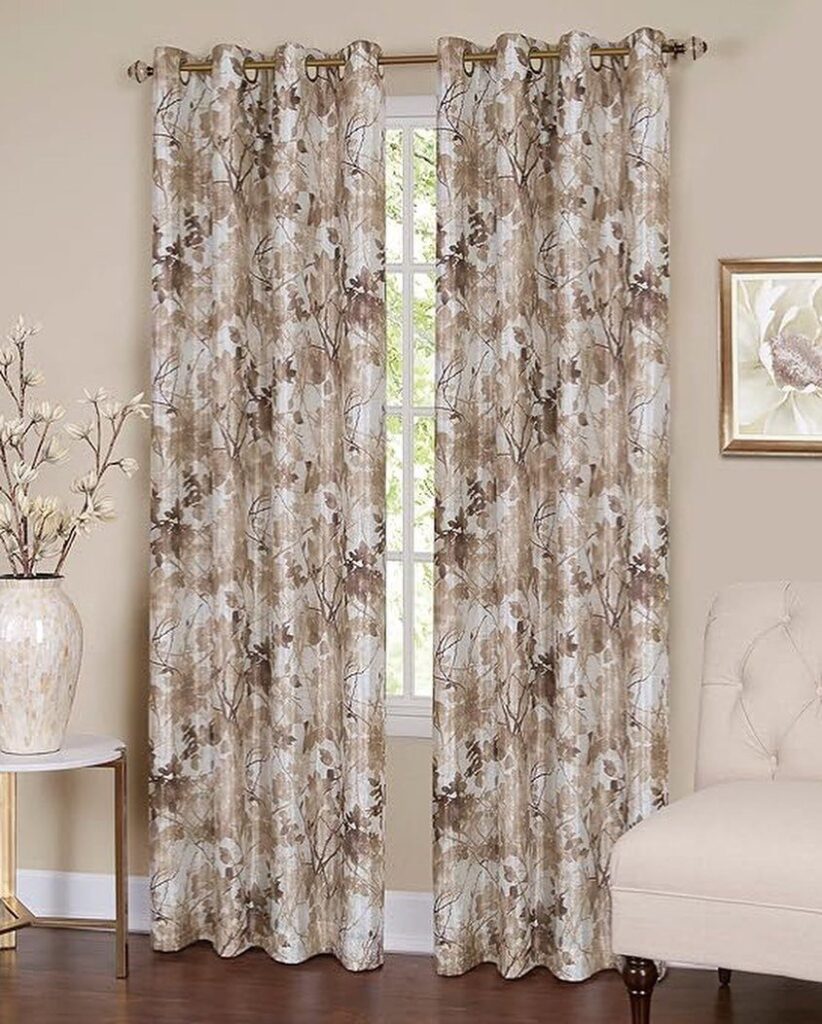 Brown patterned curtains hanging from a gold rod in a neutral living room.