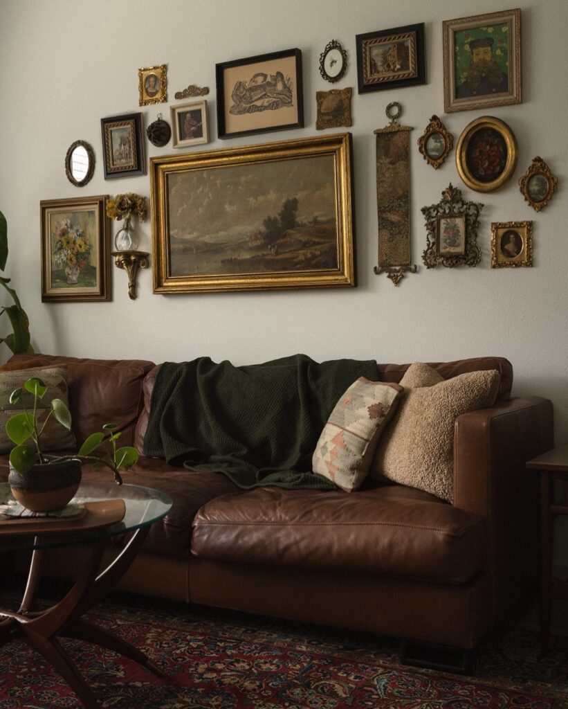 Brown leather sofa beneath a gallery wall of eclectic framed art and mirrors.