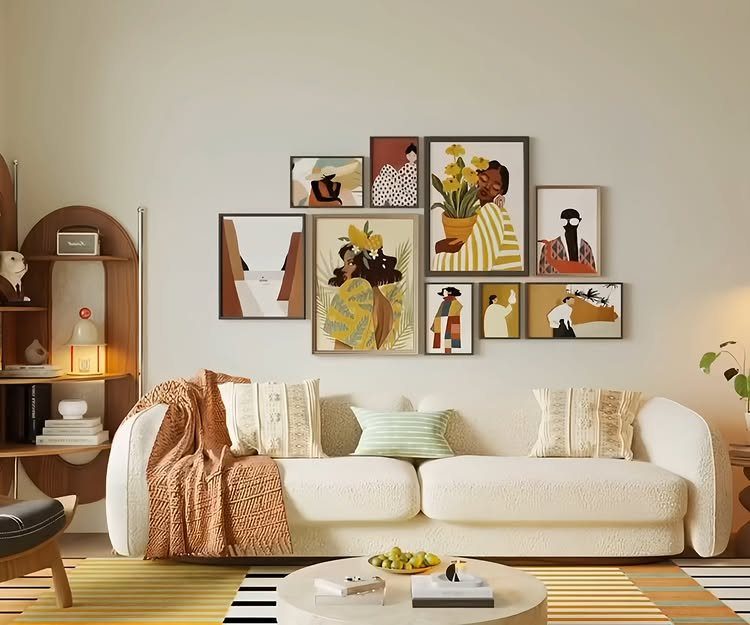 Gallery wall of abstract art frames hanging above a white textured living room sofa