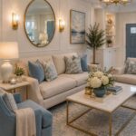 Elegant living room with beige sofa, blue accents, and gold decor elements.