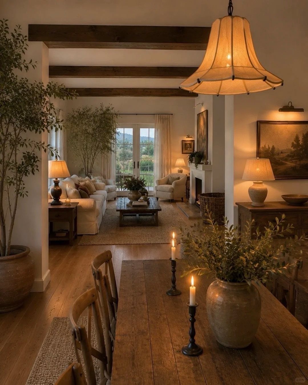 Rustic contemporary living room with wooden ceiling beams, white sofas, and warm lighting.
