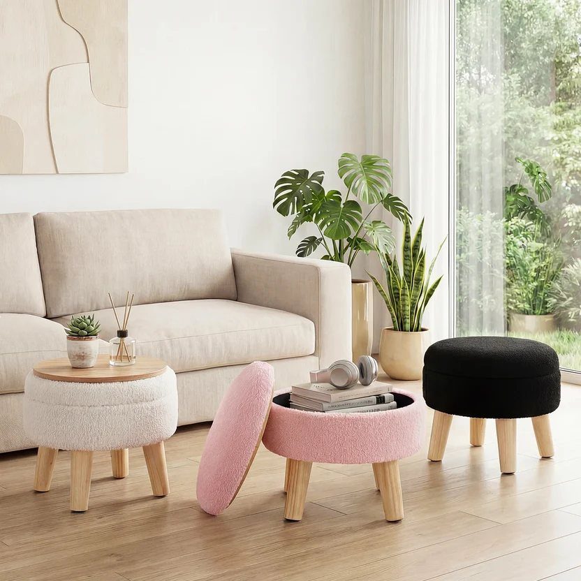 Pink storage ottoman open to reveal books and headphones in a bright living room